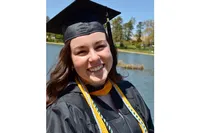 Jacklyn Motter smiles in her graduation regalia 