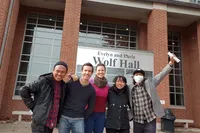 Matthew Clay-Robison poses for a group photo with members of Taring Padi in front of Wolf Hall. 