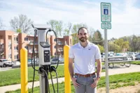 Daniel Kreiman near the on-campus electric car charging ports 