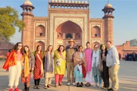 Eight students in India on a study abroad trip in front of an Indian temple 