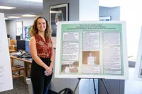 Keely Bluett in front of her undergraduate research poster 