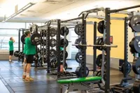 Students using the on-campus gym to weight lift 