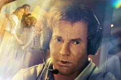 A movie poster shows a close up of actor Dennis Quaid in a cockpit, with a family of four embracing one another reflecting in the glass of the window.