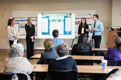 Graham School of Business students present to class on project.