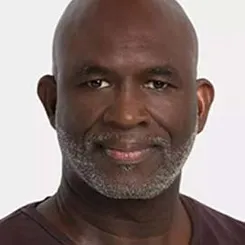 A close-up headshot of Paul Hood on a white backdrop