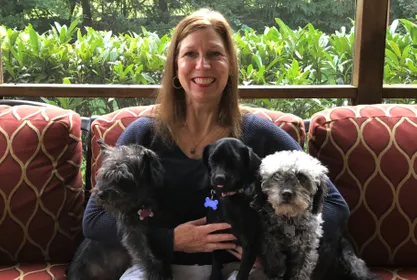 Photo of Michele Patterson and her three dogs 