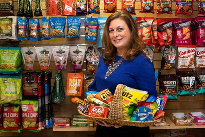 Renee in front of wall of snacks 
