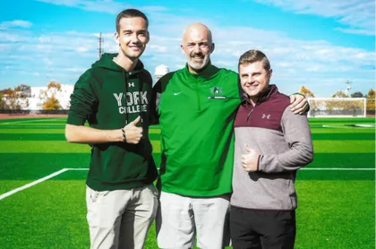 Photo of Tobias on the sport field with two YCP employees 