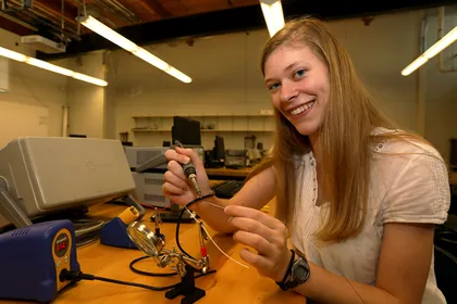 Mikayla Trost works on electrical engineering project in a lab in the Kinsley Engineering Center. 