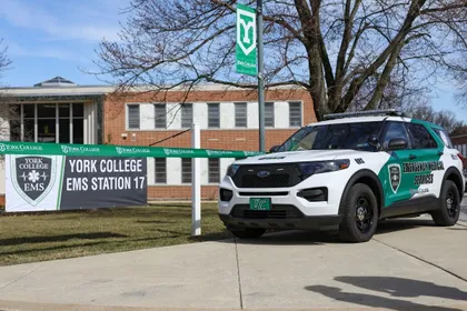New YCP Student EMS Ribbon Cutting event with a sign and the new EMS campus vehicle 