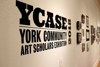 YCASE logo on the wall of the exhibit 