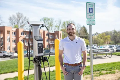 Daniel Kreiman near the on-campus electric car charging ports 