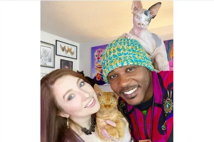 MoShow, famous alumnus, pictured with his cats and wife 