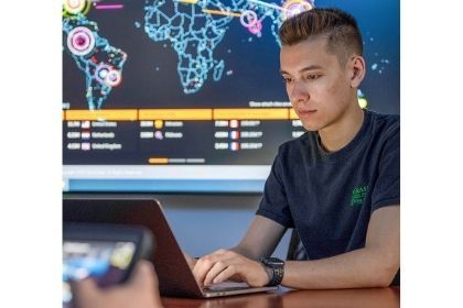 A Cybersecurity Student working on his laptop