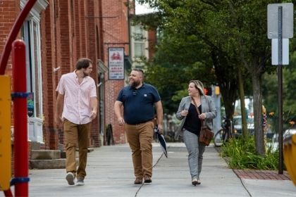 Three students walking around York City to help with Revitalization efforts