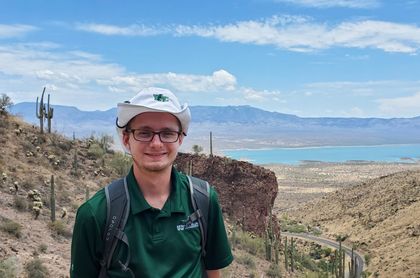 A civil engineering student posing in Arizona in front of a popular reservation.