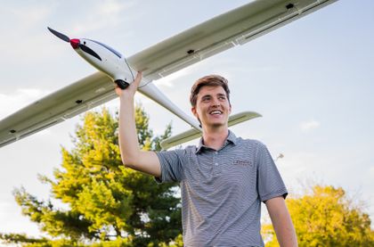 Fulbright Scholar John Kershner holding a model airplane