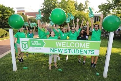 A group of Orientation leaders posing for a photo in all green