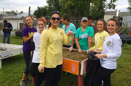 A group of Spartan help work on a community garden for Spartan Service Day 2015.
