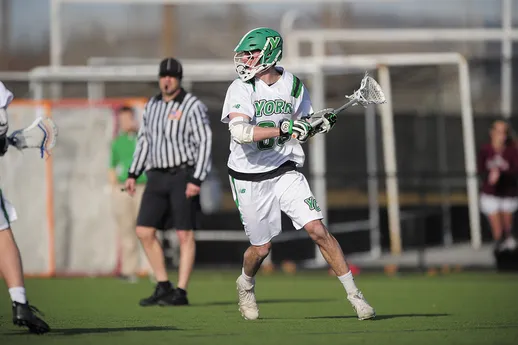 A men's lacrosse player looks upfield during a game.