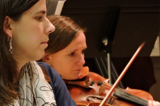 York College music professor Erin Lippard helps a student with a violin lesson