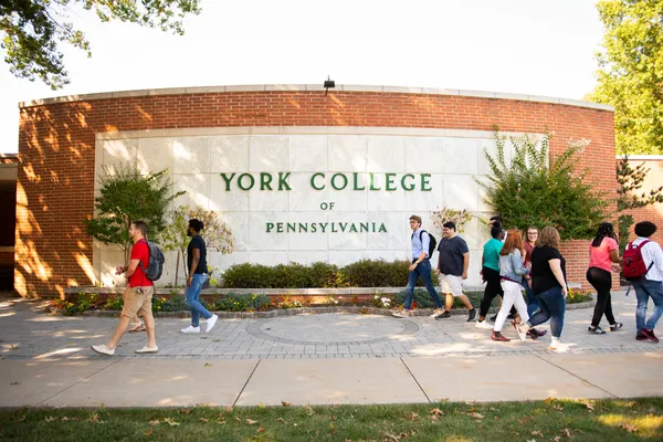 YCP Sign with students walking