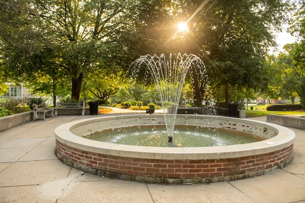 The fountain at the center of campus catches a ray of sunshine in the early morning
