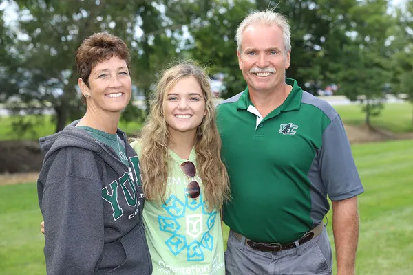 Student stands with her family during orientation weekend
