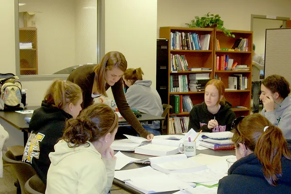 A group of students gather around a table in the Academic Success Center.